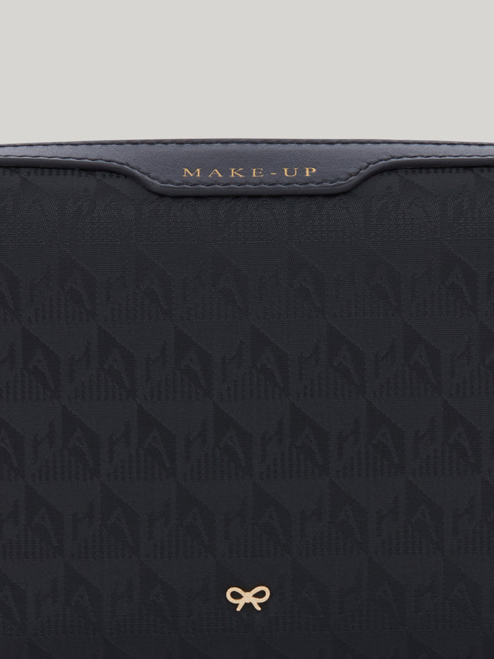 The Anya Hindmarch small make up pouch is perfect to carry your everyday essentials. Made from durable, monogrammed nylon, its spacious silhouette is split into two compartments, so you can keep your brushes safely stored and separate from your creams, blushers and bronzers in the second pocket.