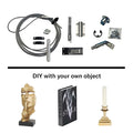 Murphy Door® DIY hardware kit with cable, fasteners and mounting components, shown with decorative objects including gold statue, style book and candle holder.