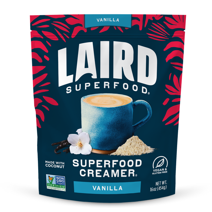 Laird Superfood Vanilla Creamer package with a blue mug and vanilla flower on a dark blue background.