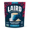 Laird Superfood Vanilla Creamer package with a blue mug and vanilla flower on a dark blue background.